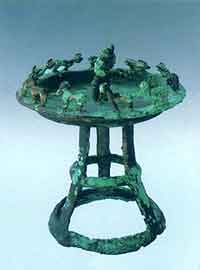 Open-work bronze plate on stand with human figures and sheep, Saka period, unearthed in Narat, Xinyuan county, in the collection of the Ili Kazak Autonomous Prefecture Museum, Yining.
