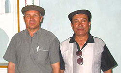 (left)Turdi Kerim, director of Cultural Relics Office in Qiemo, and (right) Ismael Ependi, translator, in male meeting room of Toghraklek Villa, Qiemo.