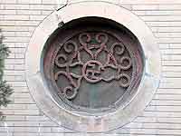 Fig. 3 Xiguanshi Mosque, wooden window screen with carved swastika design. [AHG]