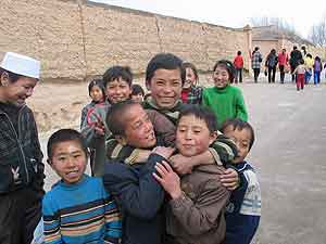 Fig. 3 Hui children in Jiucaiping, Ningxia, outside the fortified residence of the spiritual head of the Jiucaiping Qadariyya sufi order. [AH