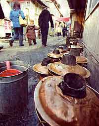 Fig. 14 The brass <i>huoguo</i> (hot-pot) fired with charcoal is the traditional implement for eating the Beijing winter favourite <i>shuan yangrou</i>.